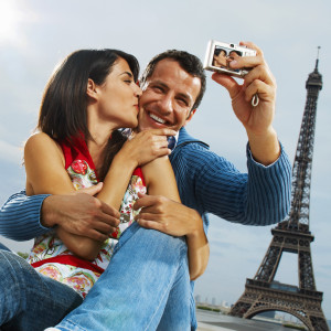 Couple Using Digital Camera in Front of Eiffel Tower